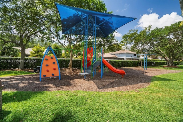 community jungle gym featuring a yard