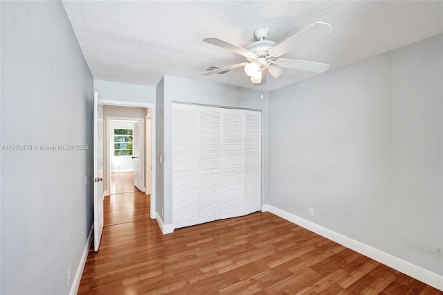 2791 La Paz Ave, Cooper City, FL 33026 - unfurnished bedroom featuring light wood-style floors, a closet, ceiling fan, and a textured ceiling