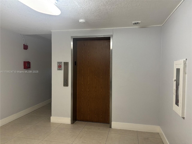 9350 Fontainebleau Blvd Unit 312, Miami, FL 33172 - hallway featuring elevator, a textured ceiling, and light tile patterned floors