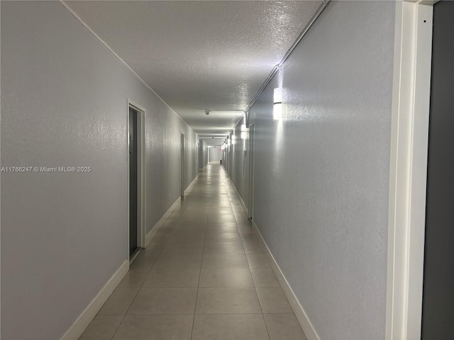 9350 Fontainebleau Blvd Unit 312, Miami, FL 33172 - hall with a textured ceiling, light tile patterned floors, and a textured wall