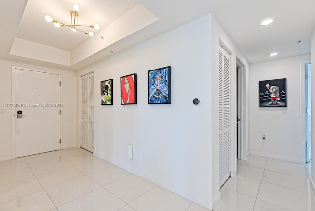 foyer entrance with recessed lighting, baseboards, a chandelier, and light tile patterned floors