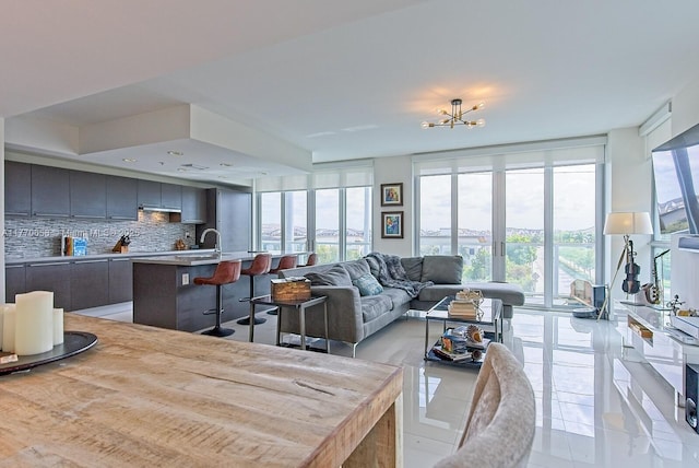 living area with expansive windows, a wealth of natural light, and light tile patterned floors