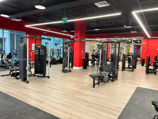 workout area with wood finished floors and visible vents