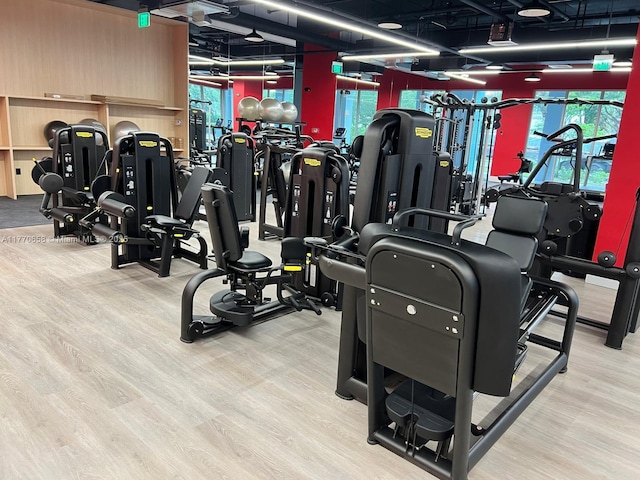 exercise room featuring wood finished floors