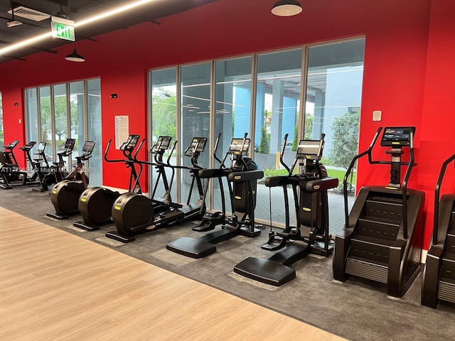 exercise room with wood finished floors and visible vents
