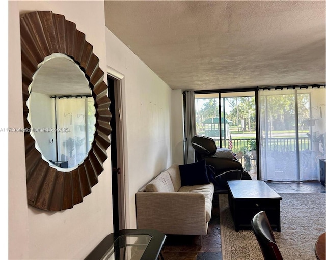 3301 N Country Club Dr Unit 110, Aventura, FL 33180 - living room with a textured ceiling and a wall of windows