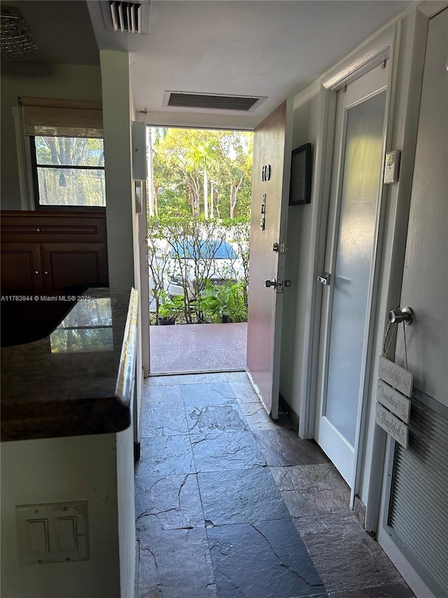 3301 N Country Club Dr Unit 110, Aventura, FL 33180 - doorway to outside with stone tile floors