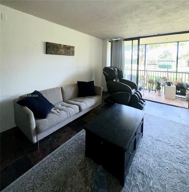 3301 N Country Club Dr Unit 110, Aventura, FL 33180 - living area featuring a healthy amount of sunlight, a wall of windows, and a textured ceiling