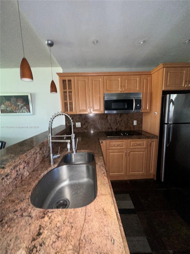 3301 N Country Club Dr Unit 110, Aventura, FL 33180 - kitchen with decorative light fixtures, backsplash, a sink, glass insert cabinets, and black appliances