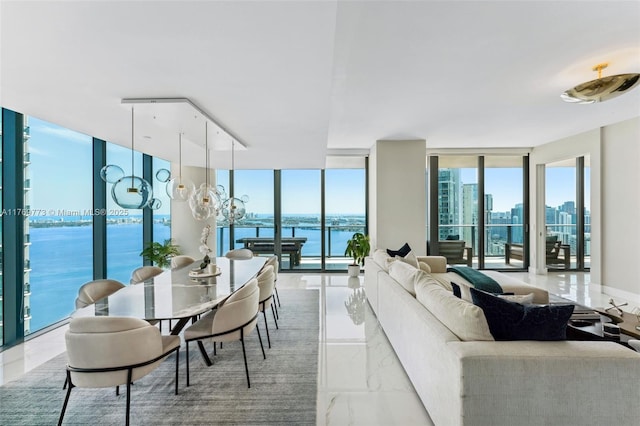 650 NE 32nd St Unit Ph5004, Miami, FL 33137 - living room with light marble finish flooring, floor to ceiling windows, and a water view