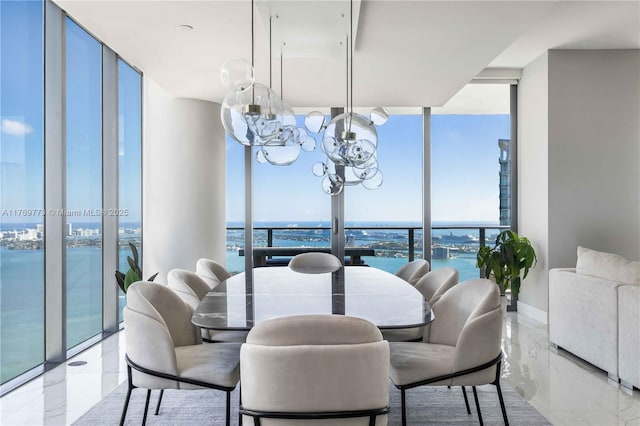 650 NE 32nd St Unit Ph5004, Miami, FL 33137 - dining space featuring expansive windows, a water view, a chandelier, and light marble finish floors