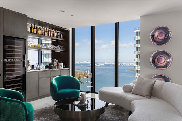 650 NE 32nd St Unit Ph5004, Miami, FL 33137 - living room featuring a dry bar, light marble finish flooring, expansive windows, healthy amount of natural light, and a water view