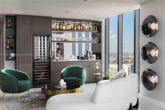 650 NE 32nd St Unit Ph5004, Miami, FL 33137 - living area featuring wine cooler, bar with sink, floor to ceiling windows, and marble finish floors
