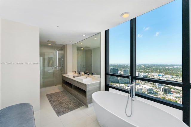 650 NE 32nd St Unit Ph5004, Miami, FL 33137 - full bath with tile patterned floors, a stall shower, a soaking tub, double vanity, and a view of city