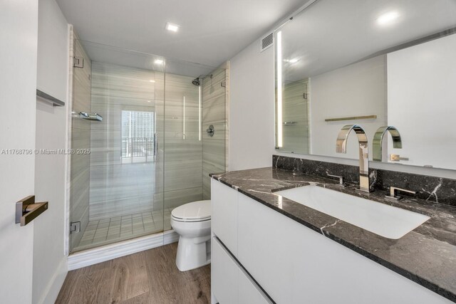 1901 Brickell Ave Unit B2304, Miami, FL 33129 - full bathroom with vanity, a stall shower, and wood finished floors