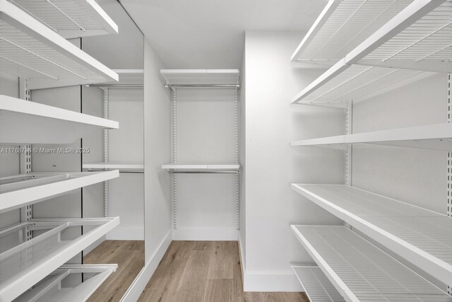 1901 Brickell Ave Unit B2304, Miami, FL 33129 - spacious closet featuring wood finished floors