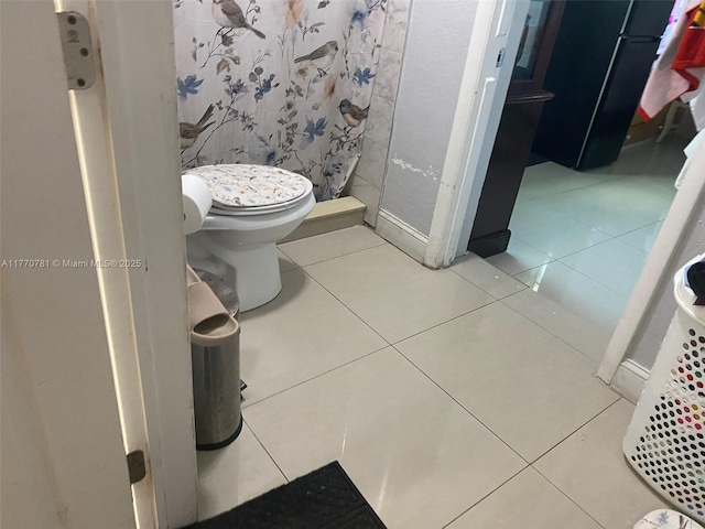 840 NE 32nd Ct, Pompano Beach, FL 33064 - full bathroom with tile patterned flooring, a stall shower, and toilet