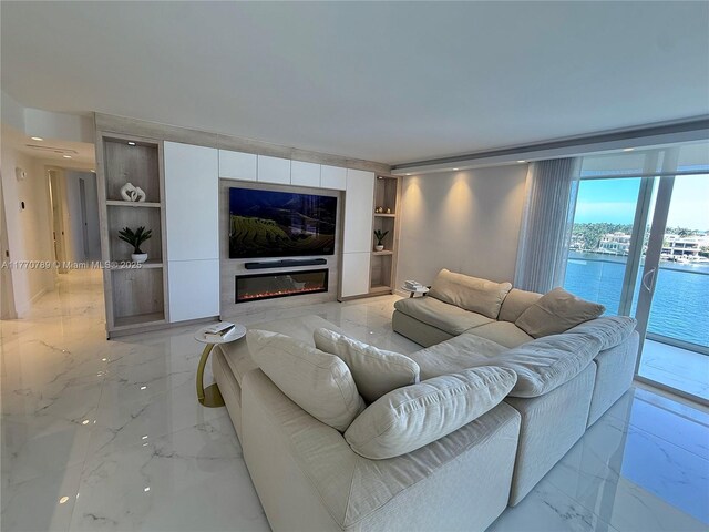 19707 Turnberry Way Unit 6E, Aventura, FL 33180 - living room featuring marble finish floor and a glass covered fireplace