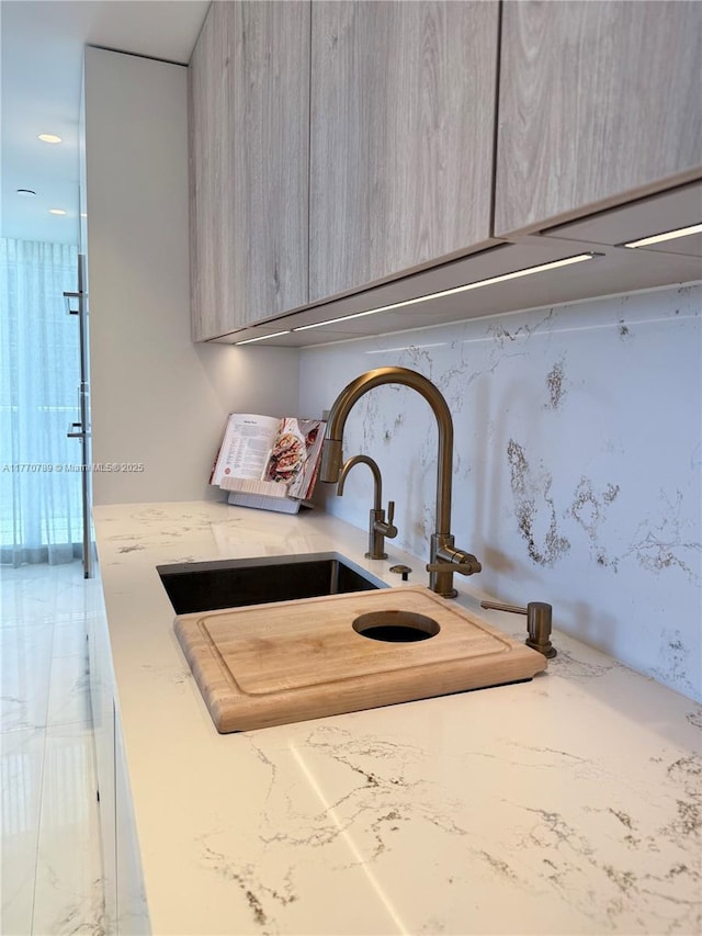 19707 Turnberry Way Unit 6E, Aventura, FL 33180 - details featuring a sink, gray cabinets, light stone countertops, and modern cabinets