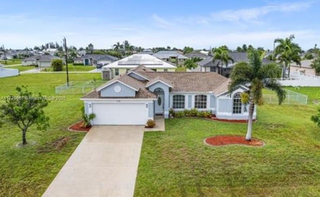 1715 NE 2nd Ave, Cape Coral, FL 33909 - view of front of house with an attached garage, concrete driveway, a residential view, and a front yard