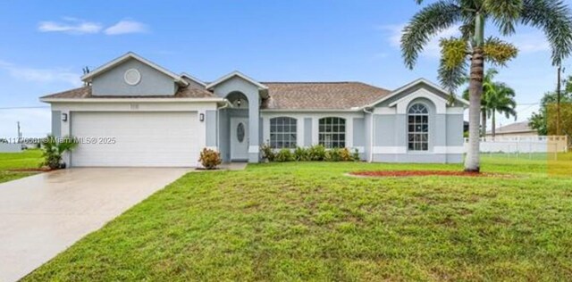 1715 NE 2nd Ave, Cape Coral, FL 33909 - single story home featuring an attached garage, stucco siding, driveway, and a front lawn