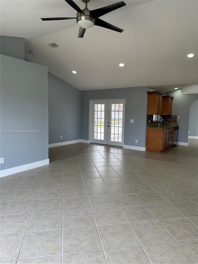 1715 NE 2nd Ave, Cape Coral, FL 33909 - unfurnished living room featuring recessed lighting, baseboards, lofted ceiling, light tile patterned floors, and a ceiling fan