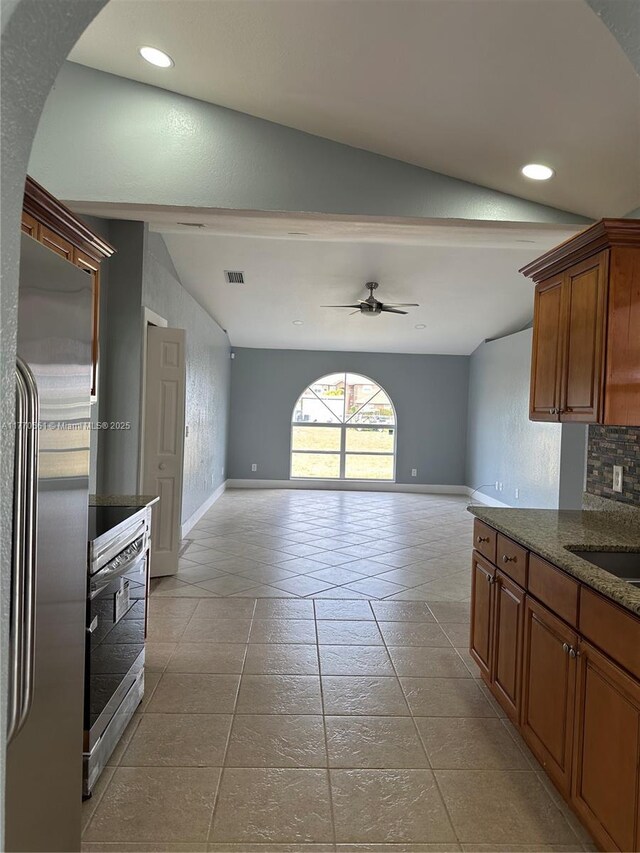 1715 NE 2nd Ave, Cape Coral, FL 33909 - kitchen with stainless steel appliances, light tile patterned flooring, ceiling fan, brown cabinetry, and recessed lighting