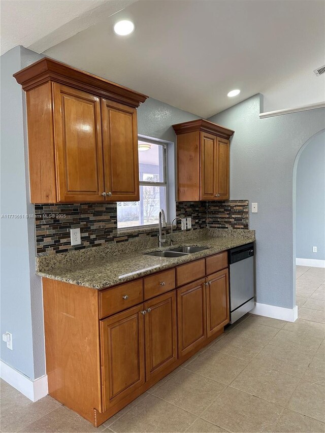 1715 NE 2nd Ave, Cape Coral, FL 33909 - kitchen with stainless steel dishwasher, a sink, brown cabinets, and recessed lighting