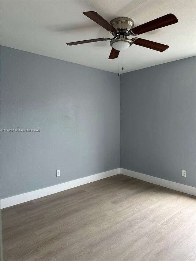 1715 NE 2nd Ave, Cape Coral, FL 33909 - empty room featuring wood finished floors, baseboards, and a ceiling fan