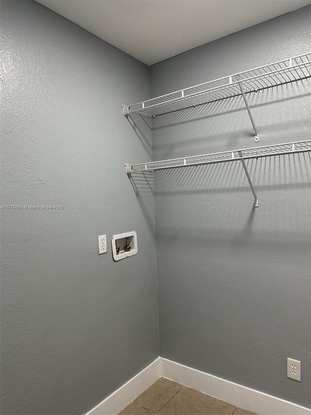 1715 NE 2nd Ave, Cape Coral, FL 33909 - laundry area featuring baseboards, hookup for a washing machine, and tile patterned flooring