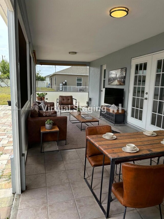 1715 NE 2nd Ave, Cape Coral, FL 33909 - sunroom with french doors and healthy amount of natural light