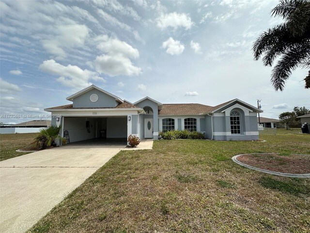 1715 NE 2nd Ave, Cape Coral, FL 33909 - ranch-style house with a garage, concrete driveway, stucco siding, and a front yard