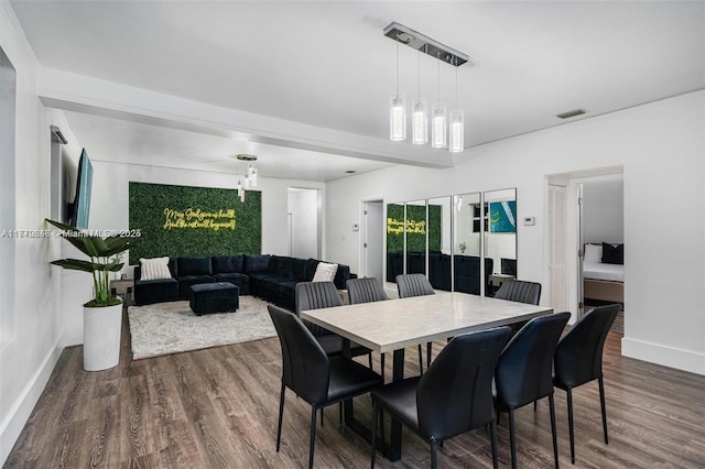 dining space featuring baseboards, visible vents, and wood finished floors