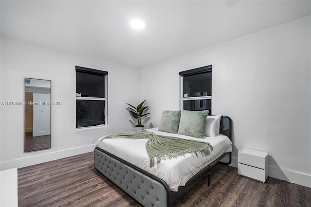 bedroom featuring baseboards and wood finished floors