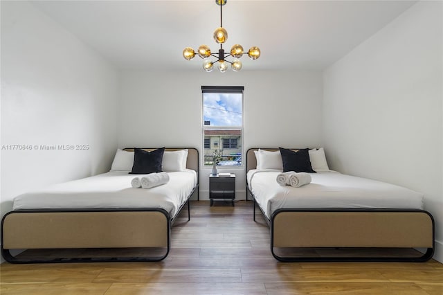 1114 SW 11th Ave, Miami, FL 33129 - bedroom with a chandelier and wood finished floors