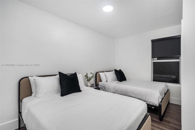 bedroom with dark wood finished floors