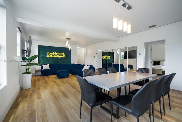1114 SW 11th Ave, Miami, FL 33129 - dining area with light wood finished floors, a chandelier, and beamed ceiling