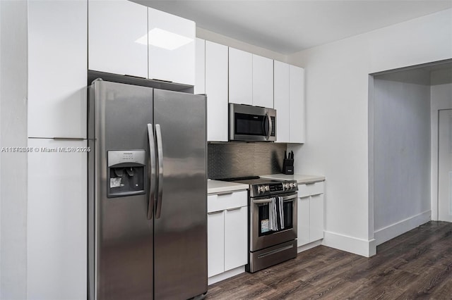 1114 SW 11th Ave, Miami, FL 33129 - kitchen featuring appliances with stainless steel finishes, dark wood-style floors, white cabinetry, light countertops, and backsplash