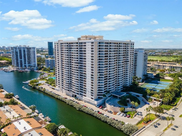 birds eye view of property featuring a city view and a water view