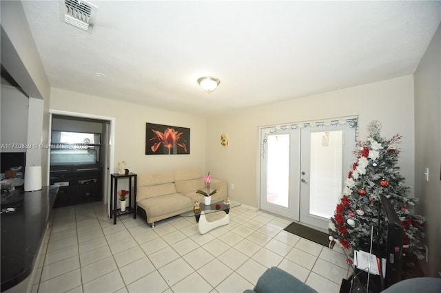 living area featuring visible vents, french doors, and light tile patterned floors