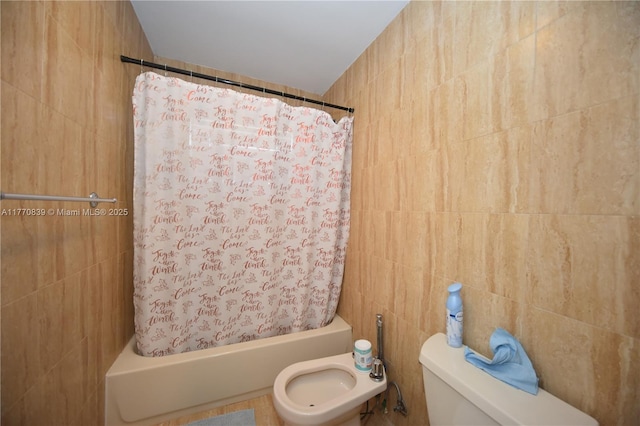 bathroom with toilet, shower / tub combo with curtain, and tile walls