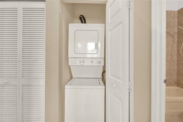 laundry room featuring stacked washer and dryer and laundry area