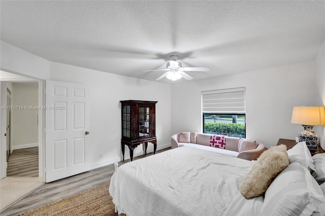 2649 Nelson Ct, Weston, FL 33332 - bedroom with light wood-style floors, a textured ceiling, and a ceiling fan