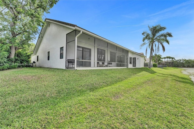 2649 Nelson Ct, Weston, FL 33332 - rear view of property with stucco siding, a yard, and a sunroom