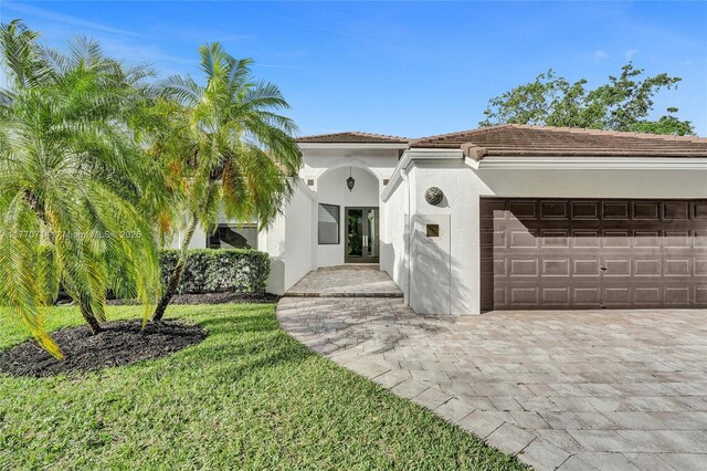 2649 Nelson Ct, Weston, FL 33332 - mediterranean / spanish home with stucco siding, a garage, and a front yard