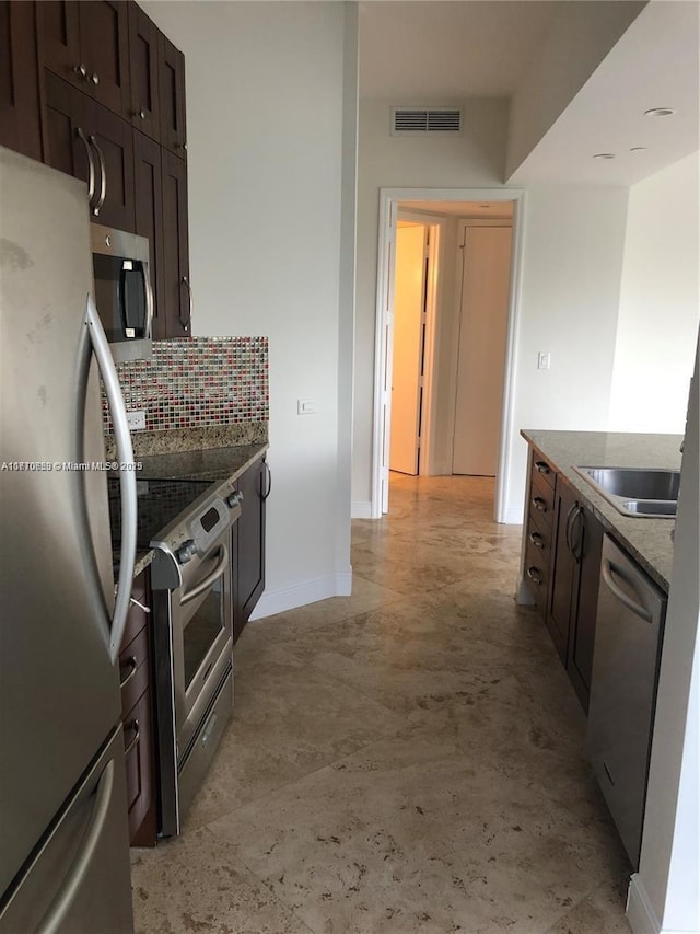 20000 E Country Club Dr Unit Ts02, Aventura, FL 33180 - kitchen with dark brown cabinetry, tasteful backsplash, visible vents, appliances with stainless steel finishes, and baseboards