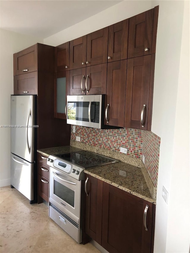 20000 E Country Club Dr Unit Ts02, Aventura, FL 33180 - kitchen featuring stainless steel appliances, dark brown cabinetry, stone countertops, and backsplash