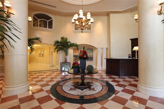 20000 E Country Club Dr Unit Ts02, Aventura, FL 33180 - interior space featuring a notable chandelier, baseboards, a high ceiling, decorative columns, and arched walkways