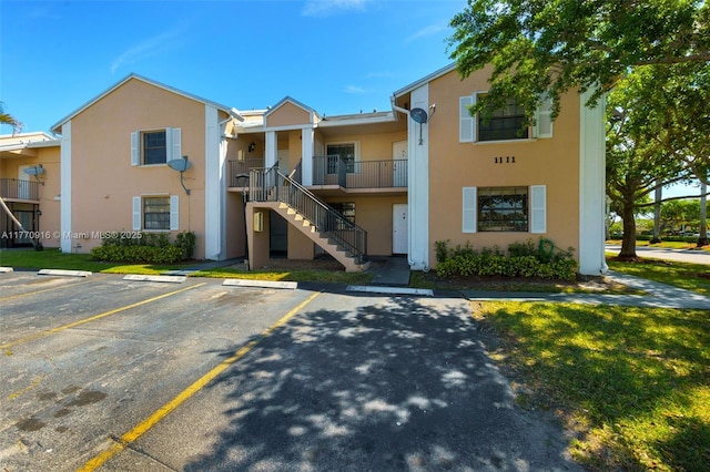 1111 Adams Ave Unit 1111B, Homestead, FL 33034 - view of building exterior featuring uncovered parking and stairway