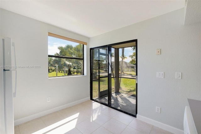 1111 Adams Ave Unit 1111B, Homestead, FL 33034 - spare room featuring baseboards, light tile patterned flooring, and plenty of natural light
